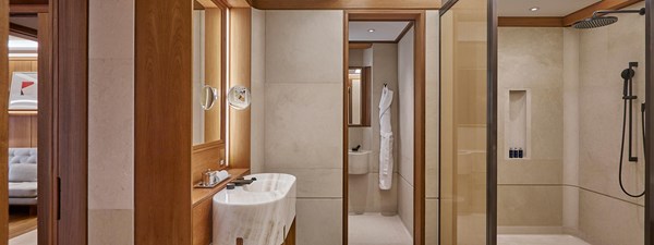 The Apartment at The Berkeley - Bathroom view with marble bath sink and shower on the right hand side.